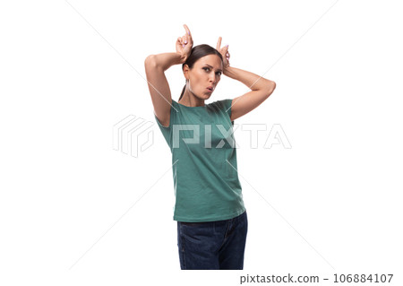 30 year old slender brunette woman with collected hair is dressed in a green basic T-shirt making a 30 year old slender brunette woman with collected hair is dressed in a green basic T-shirt making a 106884107