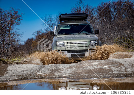 Off road tourist car rides off-road in the highlands. Expedition travel and vacation, adventures in remote areas. 106885531