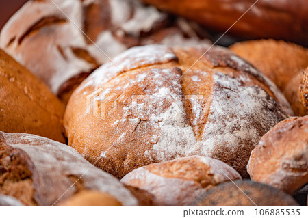 Freshly baked natural bread is on the kitchen table. Freshly baked natural bread is on the kitchen table. 106885535