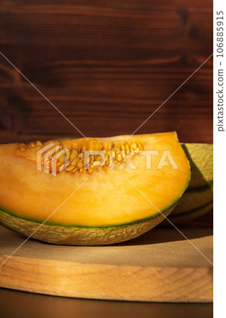 Cut yellow slices of ripe melon, close-up. A sweet delicious natural. Vertical photo 106885915