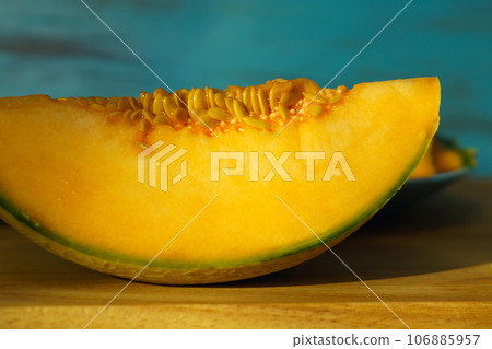 Piece of melon, close up of a table. How to peel and seed melon, close up process 106885957