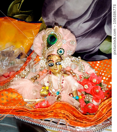 Lord Krishna also known as laddu gopal sculpture in beautiful clothes selective focus Lord Krishna also known as laddu gopal sculpture in beautiful clothes selective focus 106886778