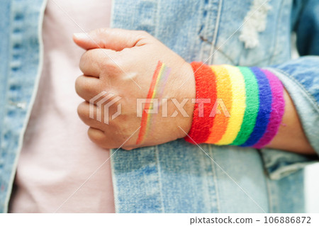 Asian woman with rainbow flag, LGBT symbol rights and gender equality, LGBT Pride Month in June. Asian woman with rainbow flag, LGBT symbol rights and gender equality, LGBT Pride Month in June. 106886872