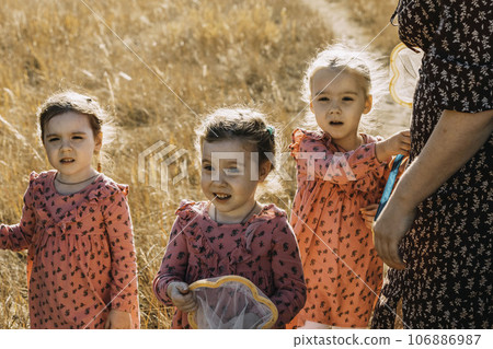 In the Heart of Autumn: Triplets Bond with Mom on a Net-Wielding Nature Walk. In the Heart of Autumn: Triplets Bond with Mom on a Net-Wielding Nature Walk. 106886987