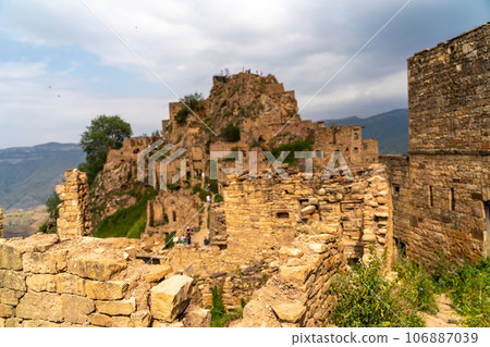 Dagestan Gamsutl. Ancient ghost town of Gamsutl old stone houses in abandoned Gamsutl mountain village in Dagestan, Abandoned etnic aul, summer landscape. 106887039