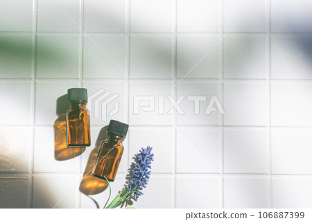 Two aroma oil bottles. An image of nature, organic, and beauty. 106887399