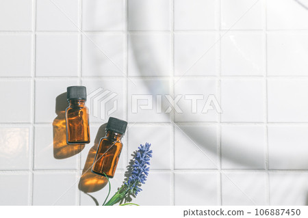 Two aroma oil bottles. An image of nature, organic, and beauty. Two aroma oil bottles. An image of nature, organic, and beauty. 106887450