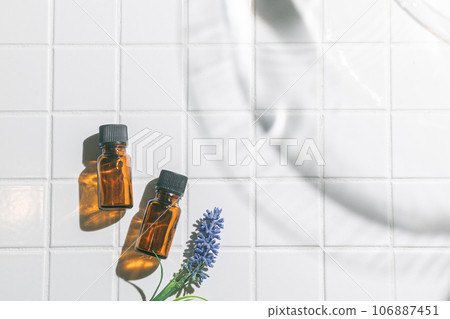 Two aroma oil bottles. An image of nature, organic, and beauty. Two aroma oil bottles. An image of nature, organic, and beauty. 106887451