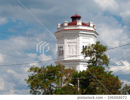 Old water tower. Industrial facility. Against the background of clouds Old water tower. Industrial facility. Against the background of clouds 106888072