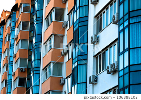 Exterior of a modern multi-story apartment building. Facade, windows and balconies. 106888102