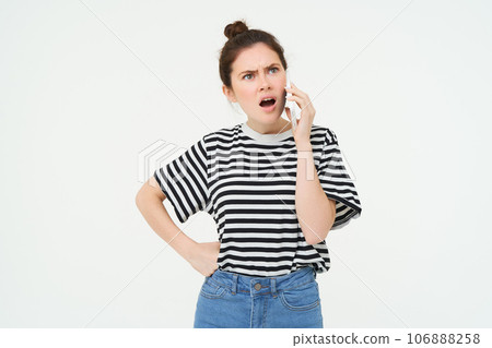Angry woman shouts at mobile phone, argues at someone over the telephone, has intense conversation over smartphone, white background Angry woman shouts at mobile phone, argues at someone over the telephone, has intense conversation over smartphone, white background 106888258