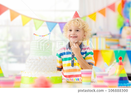 Kids birthday party. Child blowing out cake candle 106888300