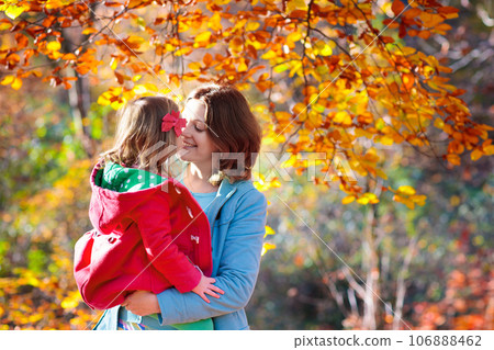 Mother and kid in autumn. Fall outdoor family fun. 106888462