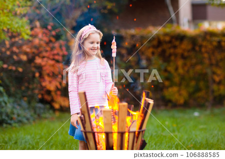 Child with smores at fire. Kids roast marshmallow. 106888585