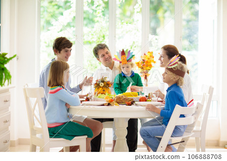 Family with kids at Thanksgiving dinner. Turkey. Family with kids at Thanksgiving dinner. Turkey. 106888708