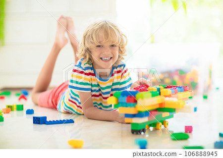 Child playing with toy blocks. Toys for kids. 106888945
