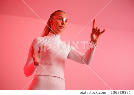 Woman in smartglasses against red background 106889555