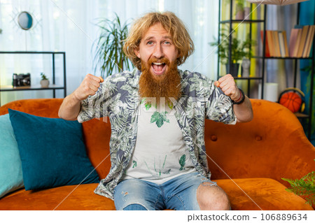 Excited happy young man surprised, shocked by sudden victory good win news celebrating wow reaction 106889634