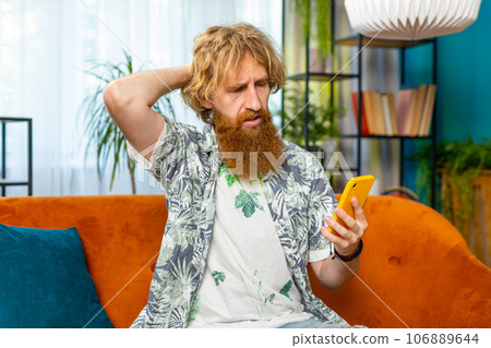Sad young man use smartphone surprised by bad news, fortune loss, fail, lottery results, deadline Sad young man use smartphone surprised by bad news, fortune loss, fail, lottery results, deadline 106889644