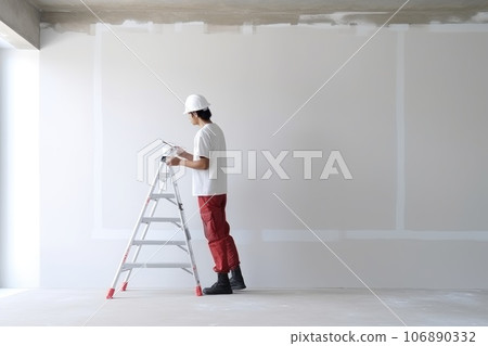 Asain male construction architect is painting the wall. Generative AI Asain male construction architect is painting the wall. Generative AI 106890332