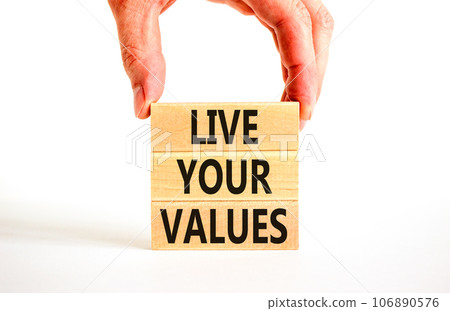 Live your values symbol. Concept words Live your values on wooden blocks. Businessman hand. Beautiful white table white background. Business, psychological and live your values concept. Copy space. 106890576