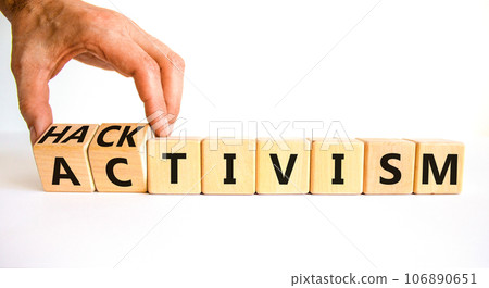 Activism or hacktivism symbol. Businessman turns wooden cubes and changes the word Activism to Hacktivism. Beautiful white table white background, copy space. Business activism or hacktivism concept. Activism or hacktivism symbol. Businessman turns wooden cubes and changes the word Activism to Hacktivism. Beautiful white table white background, copy space. Business activism or hacktivism concept. 106890651