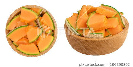 Cantaloupe melon pieces in wooden bowl isolated on white background with full depth of field. Top view. Flat lay Cantaloupe melon pieces in wooden bowl isolated on white background with full depth of field. Top view. Flat lay 106890802