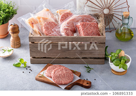 Meat delivery box, variety of meat chops and packages in a wooden crate Meat delivery box, variety of meat chops and packages in a wooden crate 106891333