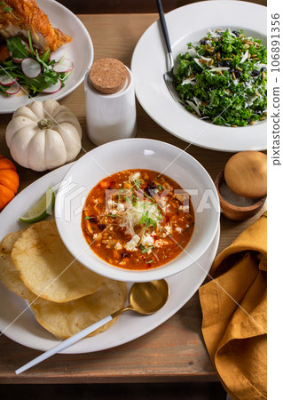 Fall dinner table with soup, salad and main dishes Fall dinner table with soup, salad and main dishes 106891356