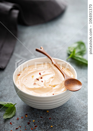 Homemade creamy chili dipping sauce or salad dressing 106891370