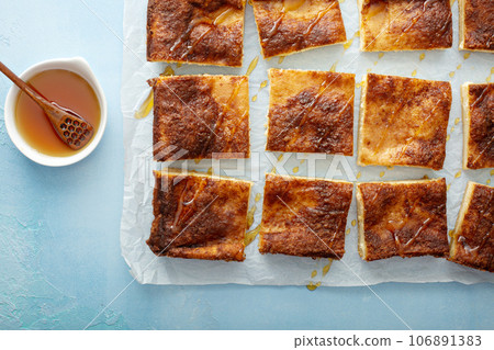 Cinnamon honey cheesecake pie cit into squares Cinnamon honey cheesecake pie cit into squares 106891383