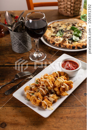 Popcorn shrimp appetizer with marinara sauce 106891392
