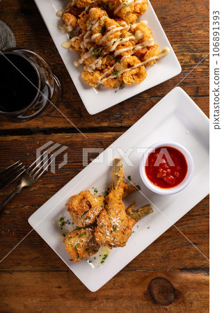 Italian fried lamb chops served with marinara sauce 106891393