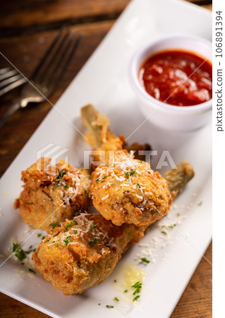 Italian fried lamb chops served with marinara sauce Italian fried lamb chops served with marinara sauce 106891394