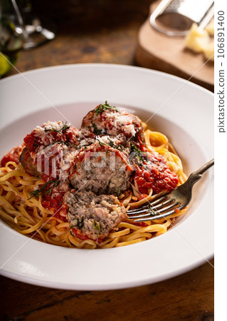 Spaghetti with meatballs and marinara sauce on a wooden table Spaghetti with meatballs and marinara sauce on a wooden table 106891400