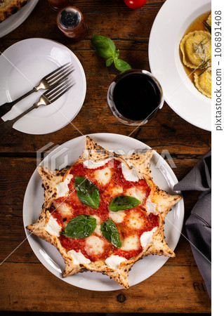 Freshly baked carnival pizza margarita with fresh basil 106891408
