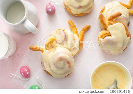 Easter breakfast rolls with orange glaze shaped like a bunny 106891456