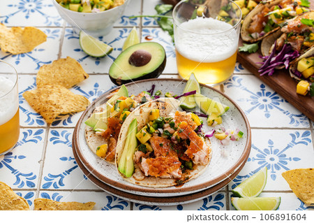 Fish tacos with mango salsa and red cabbage Fish tacos with mango salsa and red cabbage 106891604