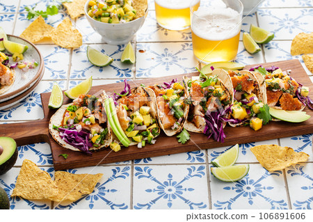 Fish tacos with mango salsa and red cabbage 106891606