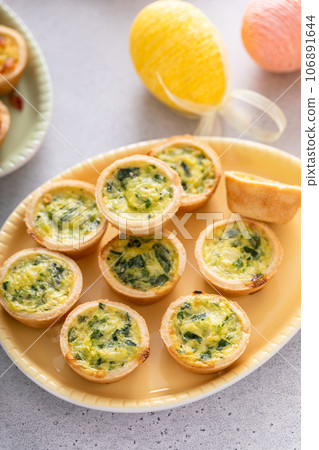 Mini quiches with spinach for Easter brunch Mini quiches with spinach for Easter brunch 106891644