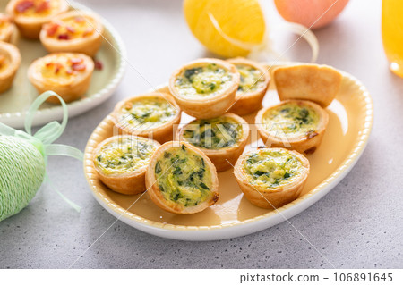 Mini quiches with spinach for Easter brunch Mini quiches with spinach for Easter brunch 106891645