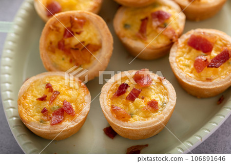 Mini quiches with bacon for Easter brunch Mini quiches with bacon for Easter brunch 106891646