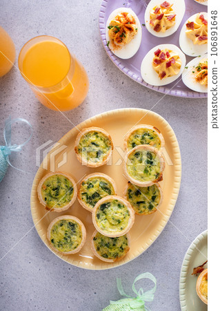 Mini quiches with spinach for Easter brunch 106891648