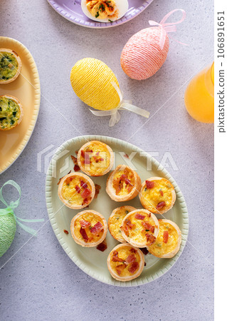 Mini quiches with bacon for Easter brunch Mini quiches with bacon for Easter brunch 106891651