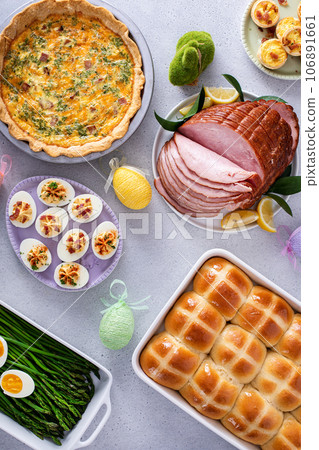 Easter brunch table with ham, quiche, hot cross buns Easter brunch table with ham, quiche, hot cross buns 106891661