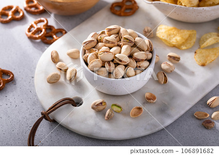 Variety of salty snacks on the table, snacks to go with beer Variety of salty snacks on the table, snacks to go with beer 106891682