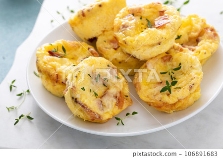 Bacon and cheddar egg muffins for breakfast Bacon and cheddar egg muffins for breakfast 106891683