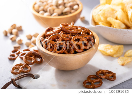 Variety of salty snacks on the table, snacks to go with beer Variety of salty snacks on the table, snacks to go with beer 106891685
