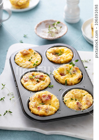 Bacon and cheddar egg muffins for breakfast 106891698