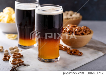 Half and half beer cocktail with lager and dark stout Half and half beer cocktail with lager and dark stout 106891747